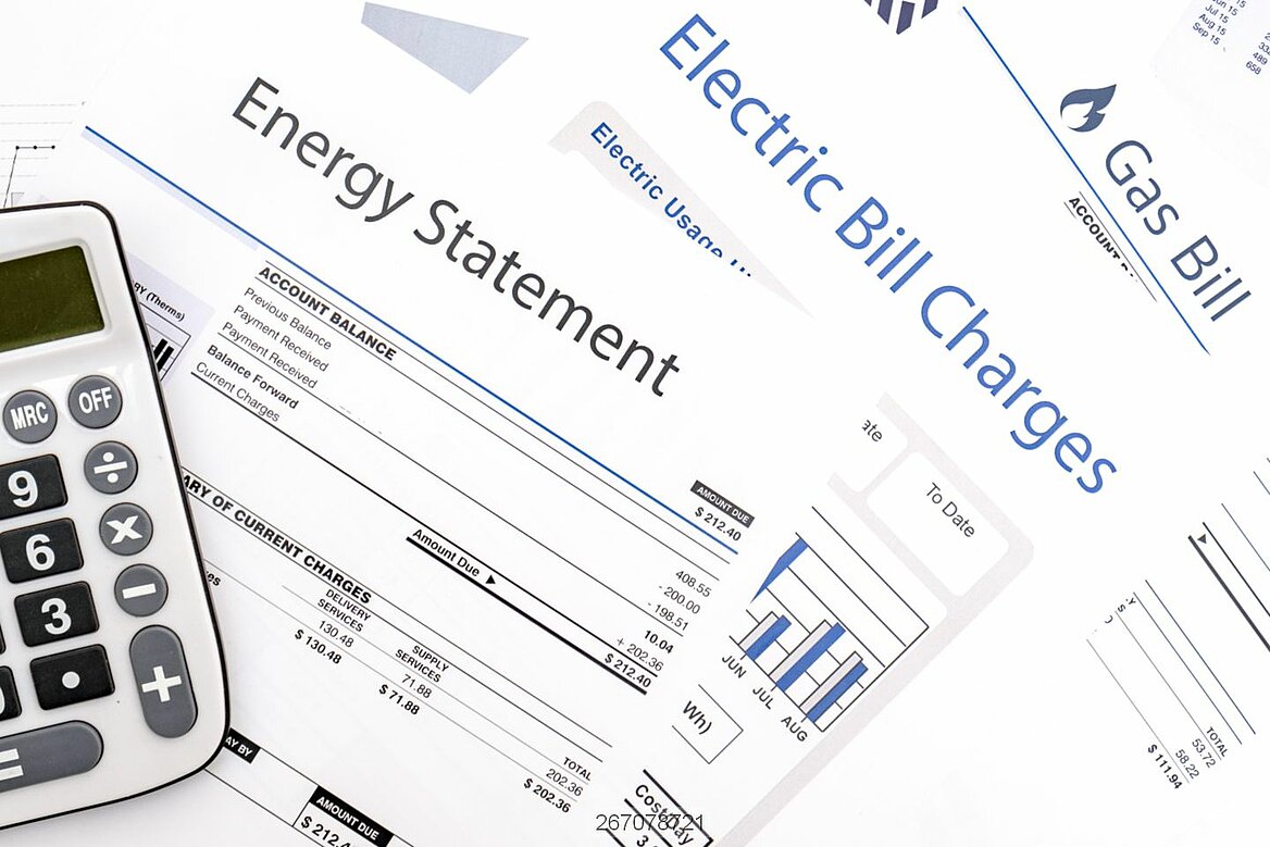 Energy bills on table with calculator
