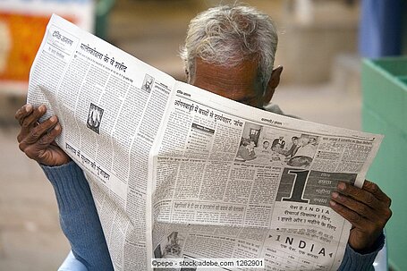 Man reading Indian newspaper